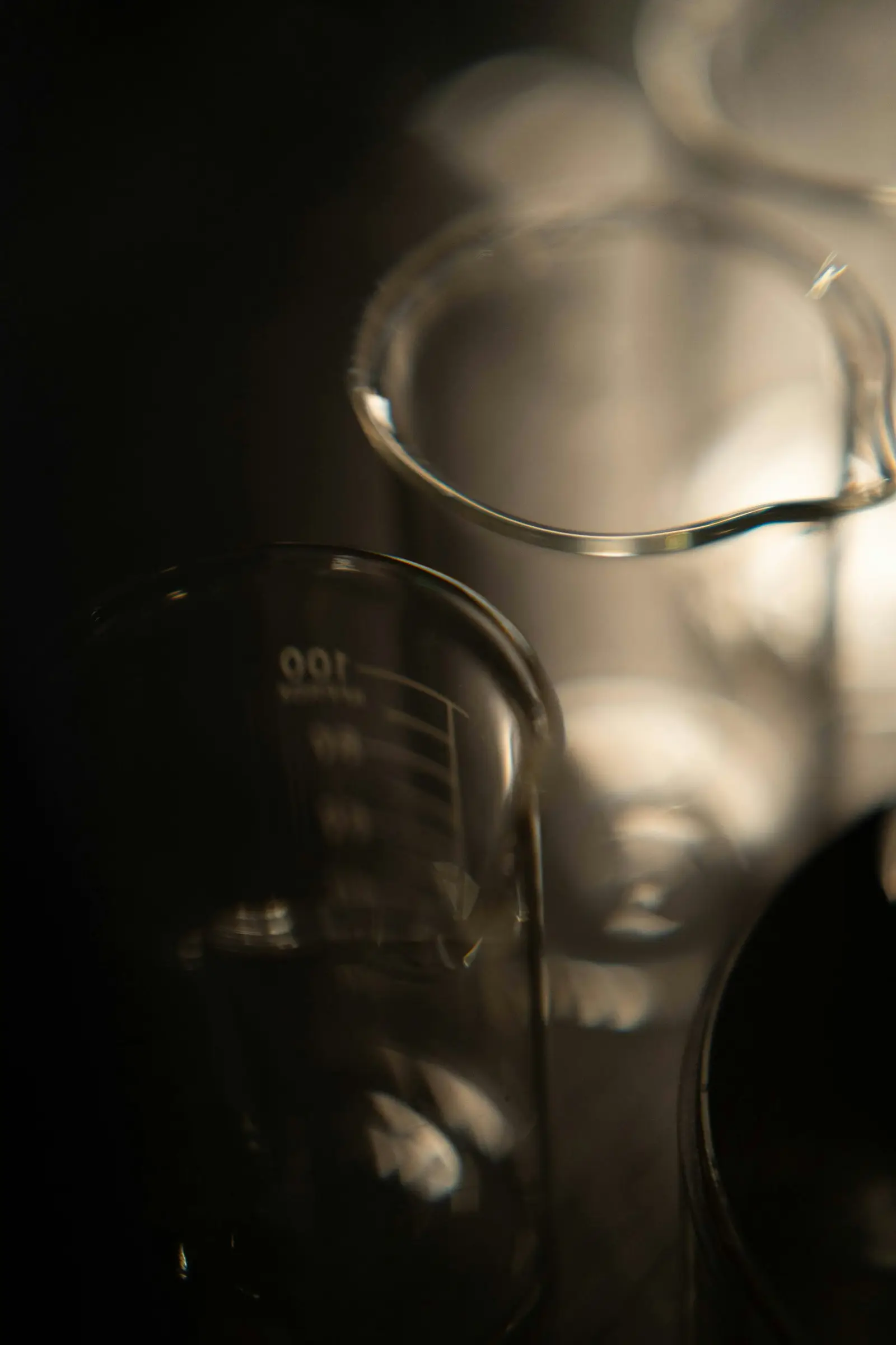 Laboratory beakers on a dark background